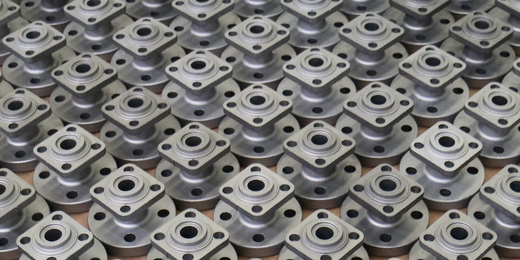 Closed-die forged ball valve bodies on the pallet, blasted to Sa 2½ and ready for machining.